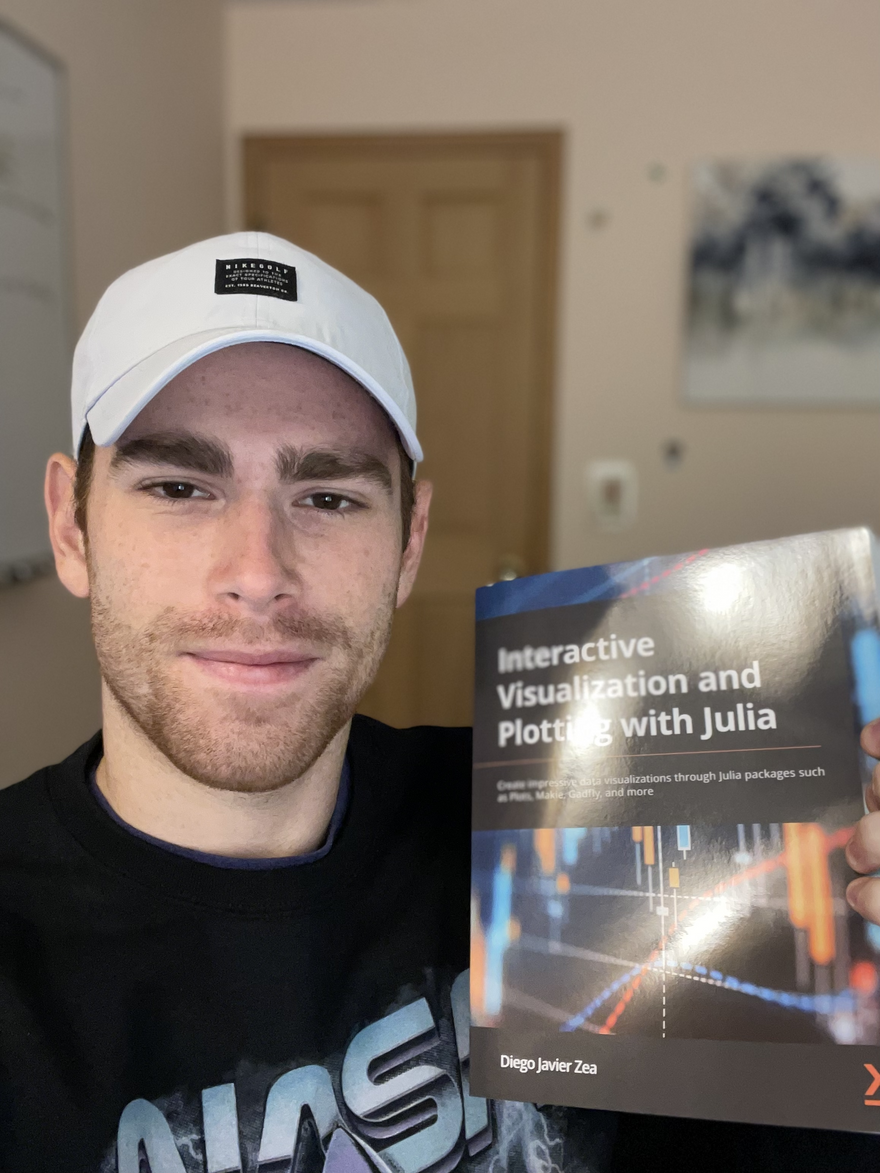 Picture of Logan holding the visualization in Julia book